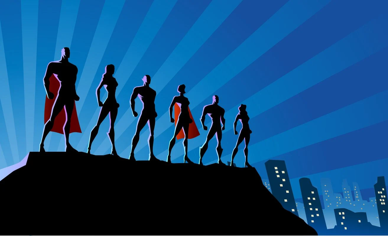 Silhouettes of six superheroes on a rocky peak above a blue city skyline