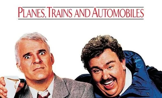 Film poster titled Planes, Trains and Automobiles showing two men, one wide-eyed and one laughing